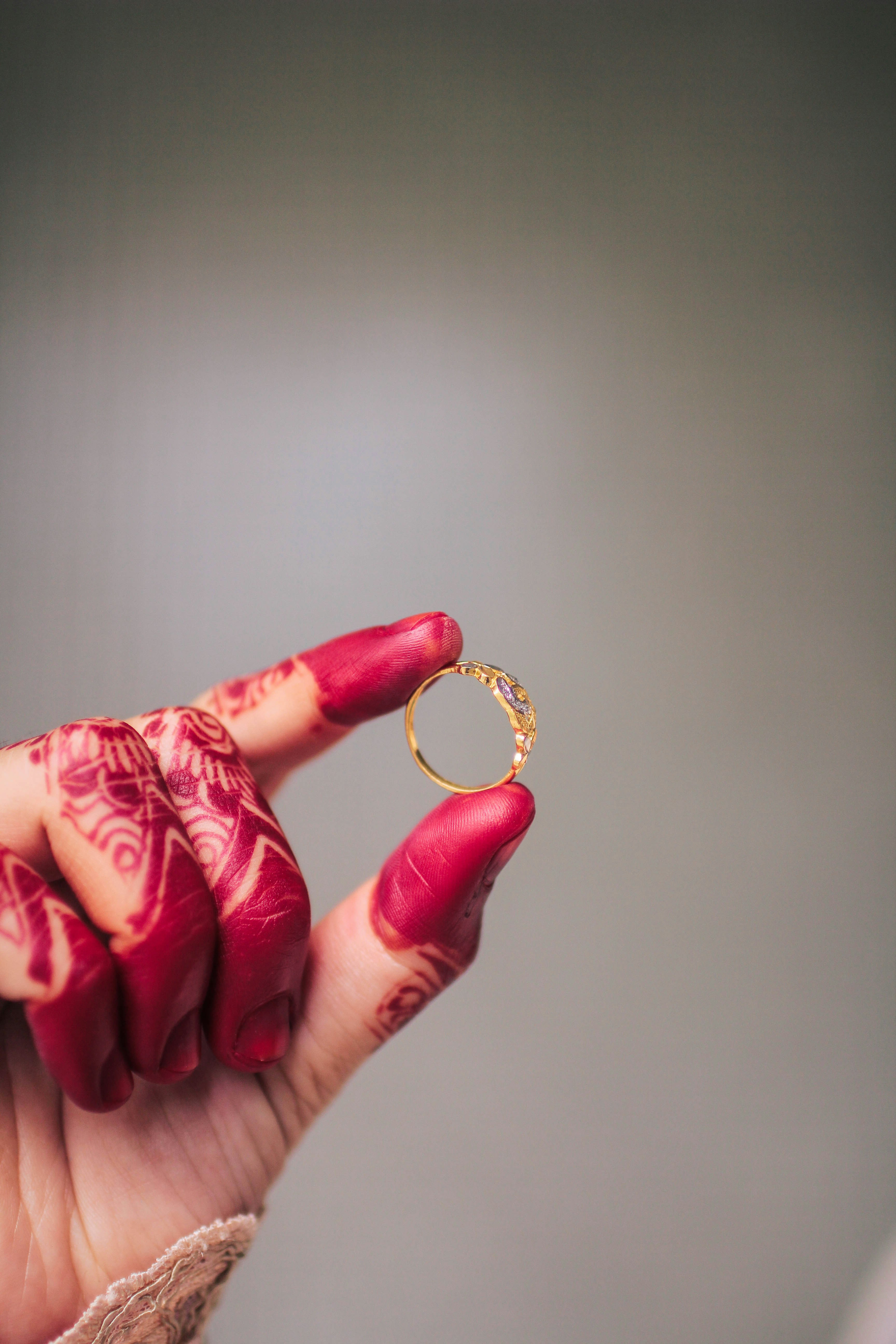person holding gold-colored ring