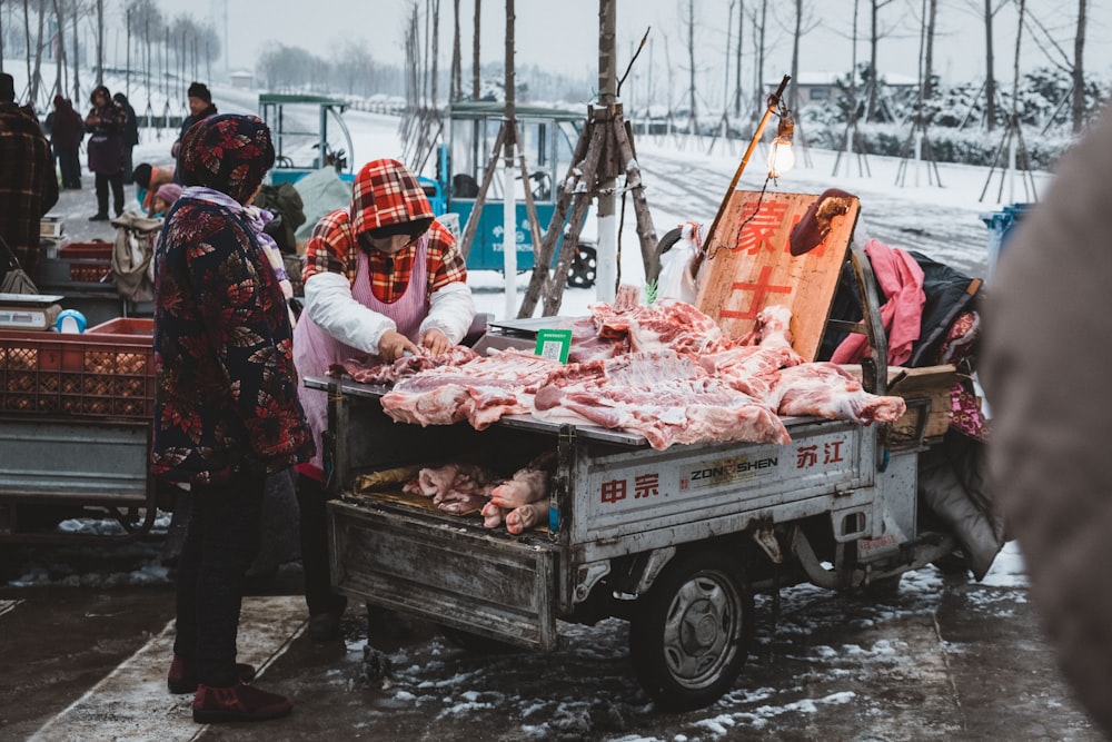 man standing in front meat