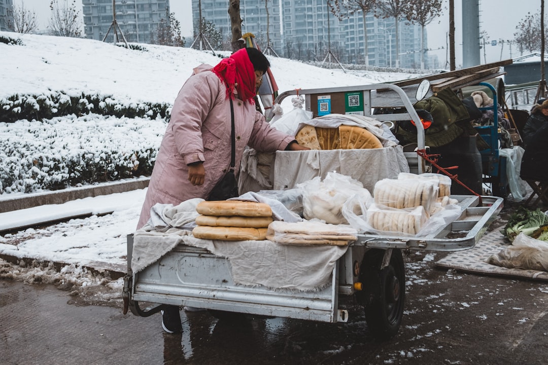 man in front of gray food cart