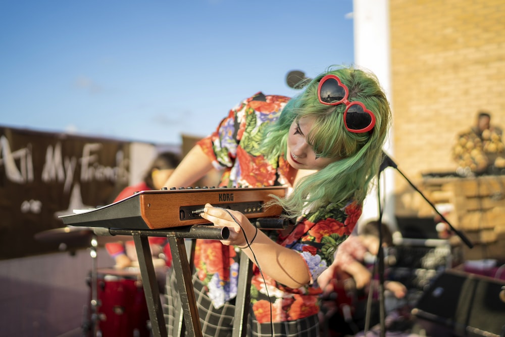 woman standing beside brown electronic keyboard