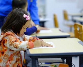 toddler sitting on desk