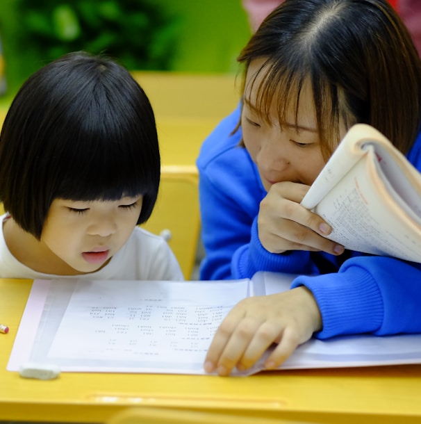 woman teaching girl