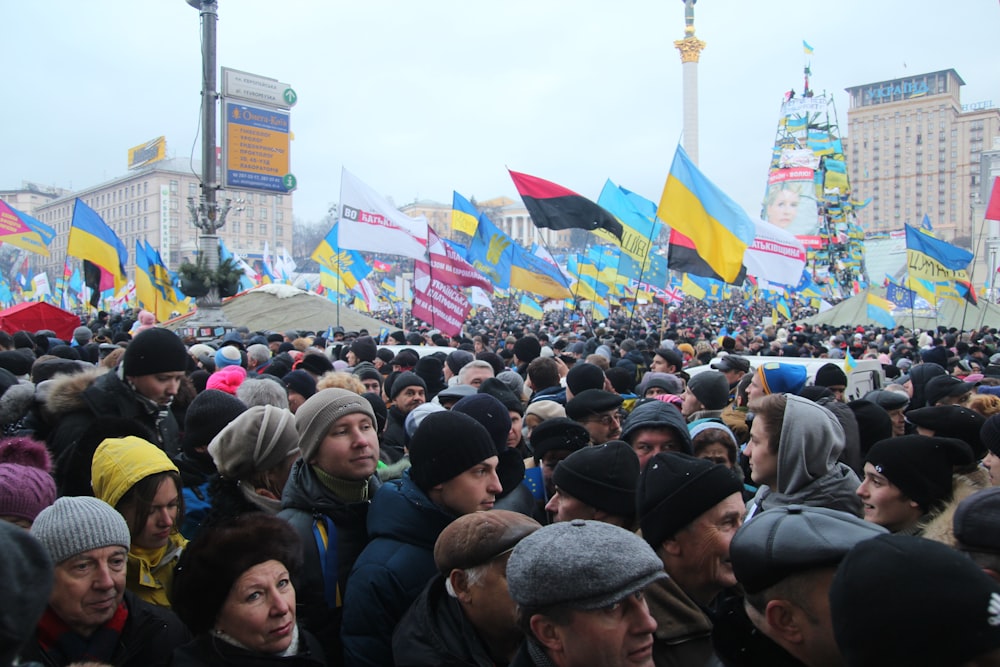 group of people standing holding flags