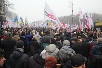 A peaceful protest in a city square under soft daylight.