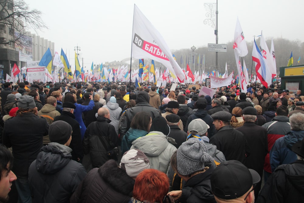 group of people gathering in front of white concrete building