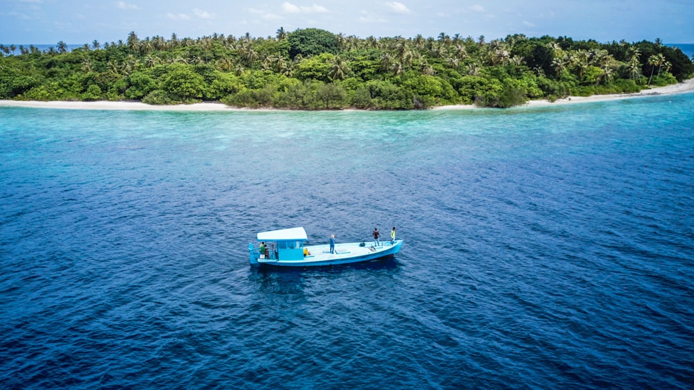 white boat on body of water during daytime