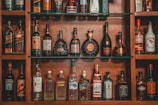 assorted liquor on brown wooden shelf
