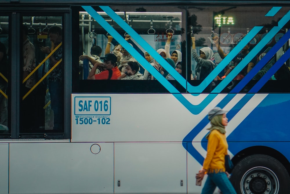 person walking beside bus