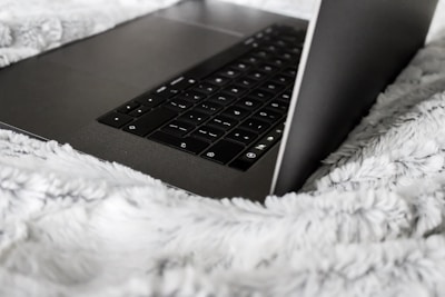 A technician repairing a laptop in a cozy home environment.