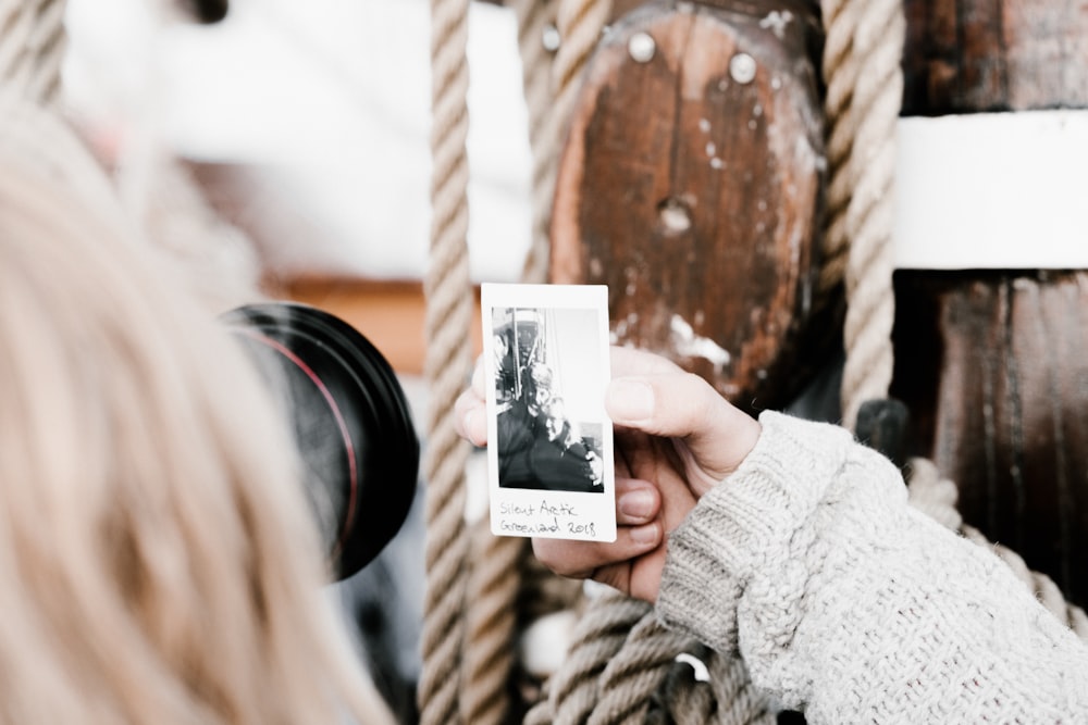 woman taking photo using black DSLR camera