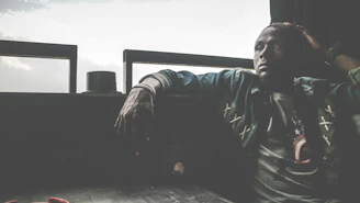 A contemplative person sitting by a window, journaling thoughts during a quiet moment of reflection.