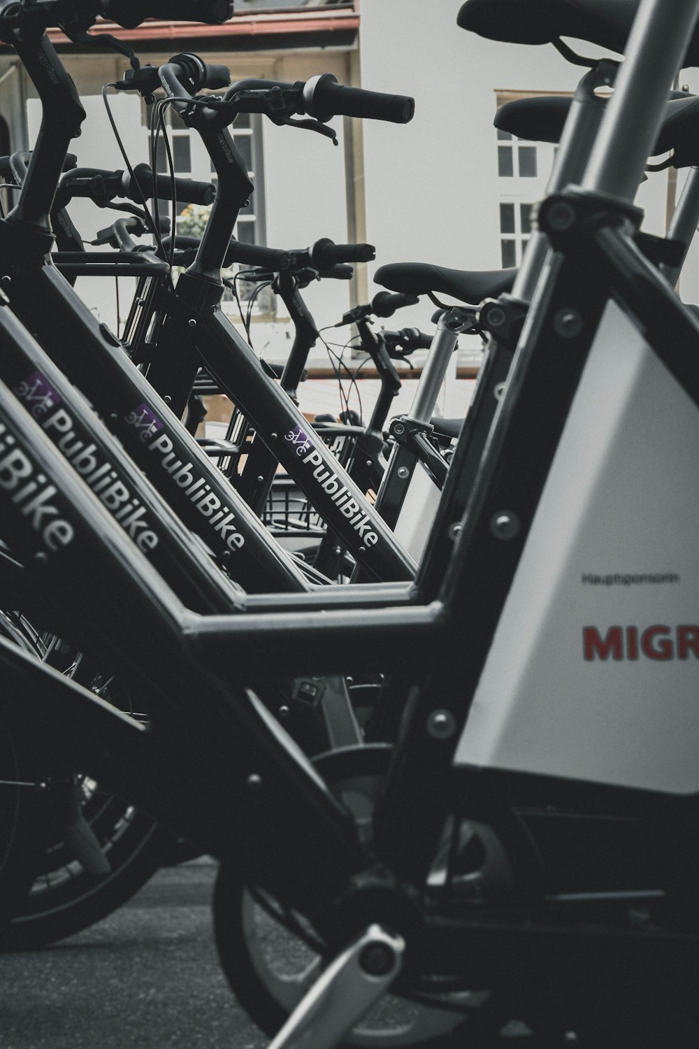 black PubliBike bikes parked near building