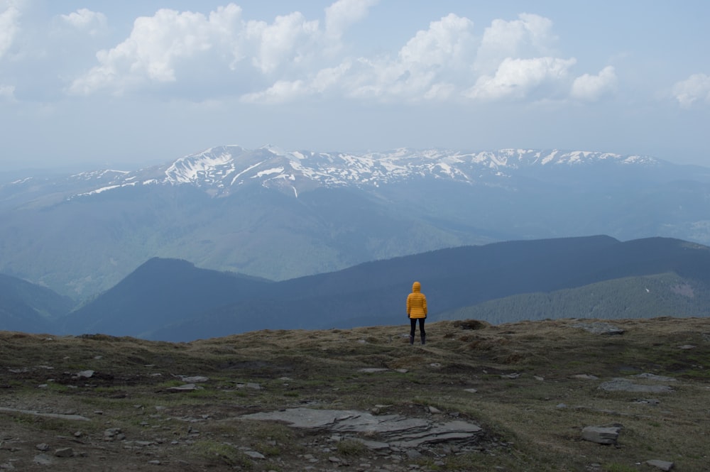 person standing near cliff during daytime