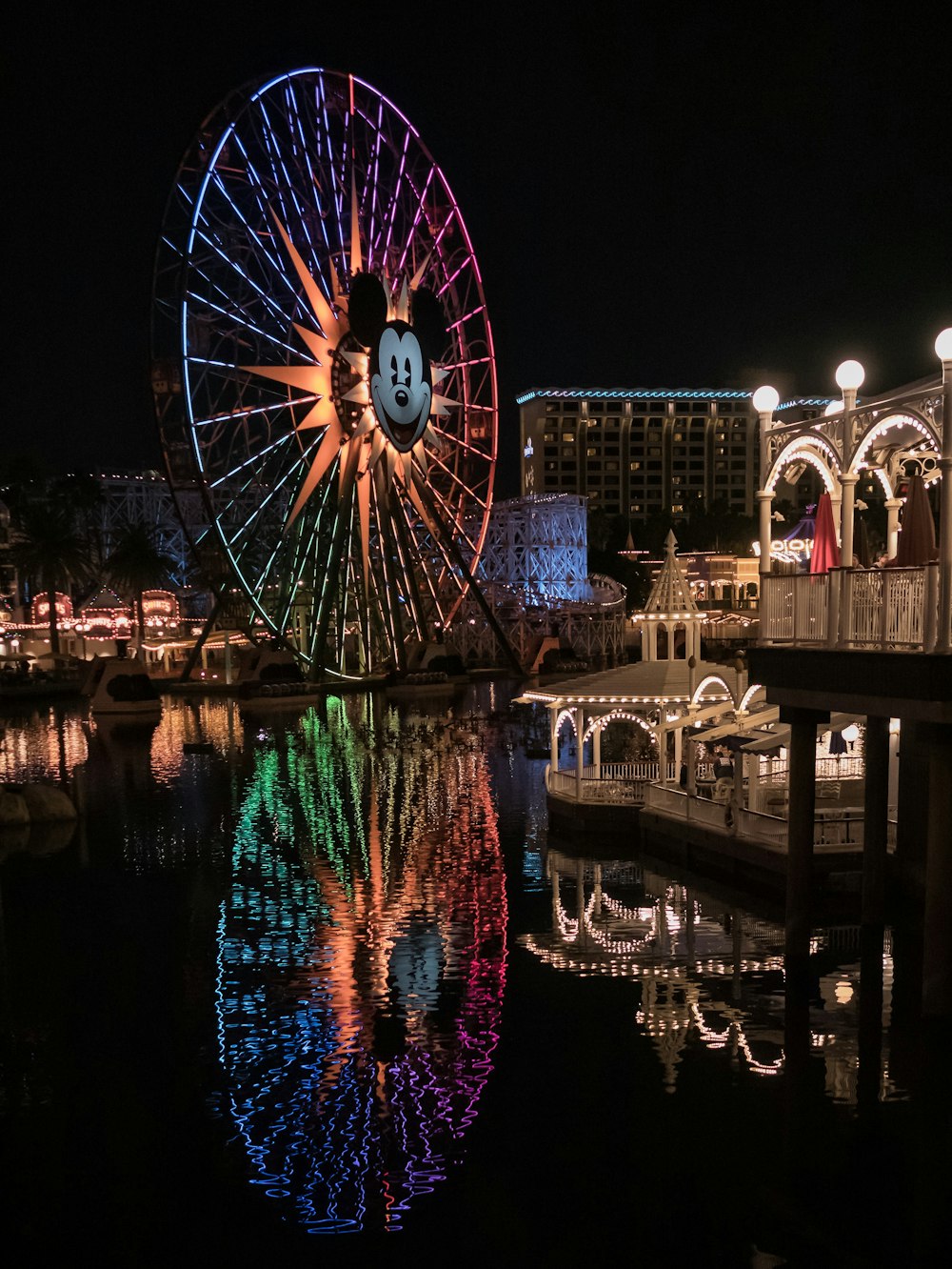 blue, pink, and orange Mickey Mouse ferries wheel at night time