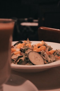 Close-up of a tropical salad featuring ripe avocado, juicy mango, and crunchy coconut flakes.