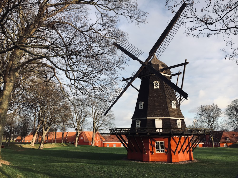 black and orange windmill near trees