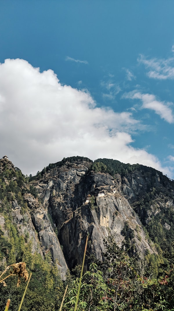 Misty grey mountain peaks shrouded in clouds on the Druk Path Trek in Paro Bhutan