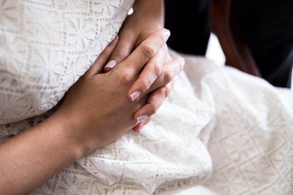 a close up of a person holding another person's hand