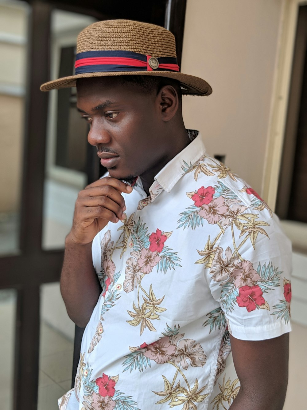 man wearing hat and floral t-shirt