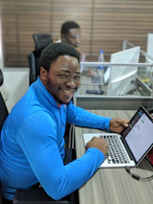 smiling man using laptop computer