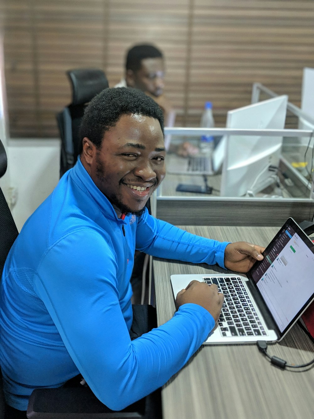 smiling man using laptop computer