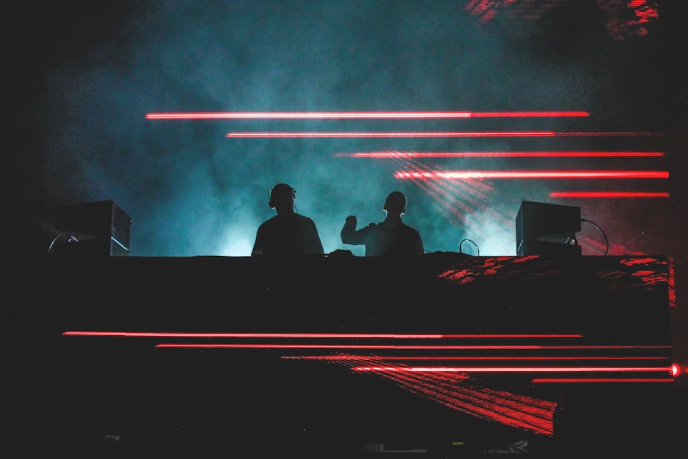 two men standing in front of smoke