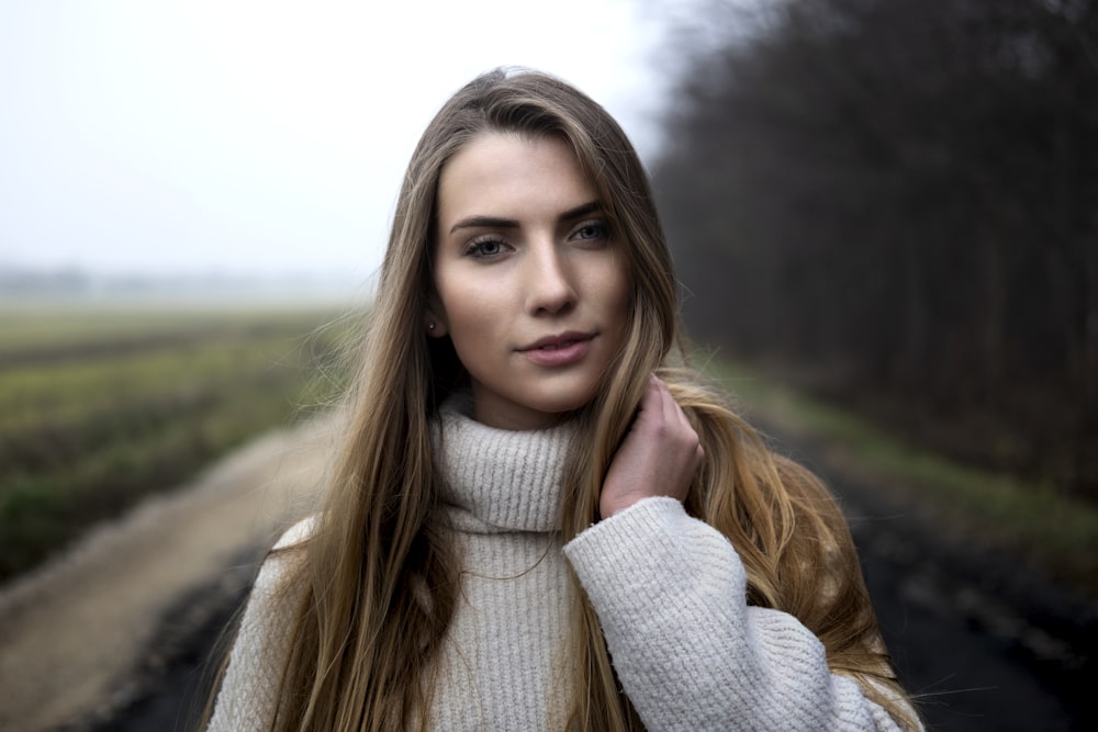 woman holding he hair