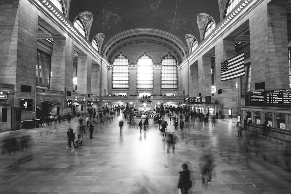 grayscale photography of people inside building