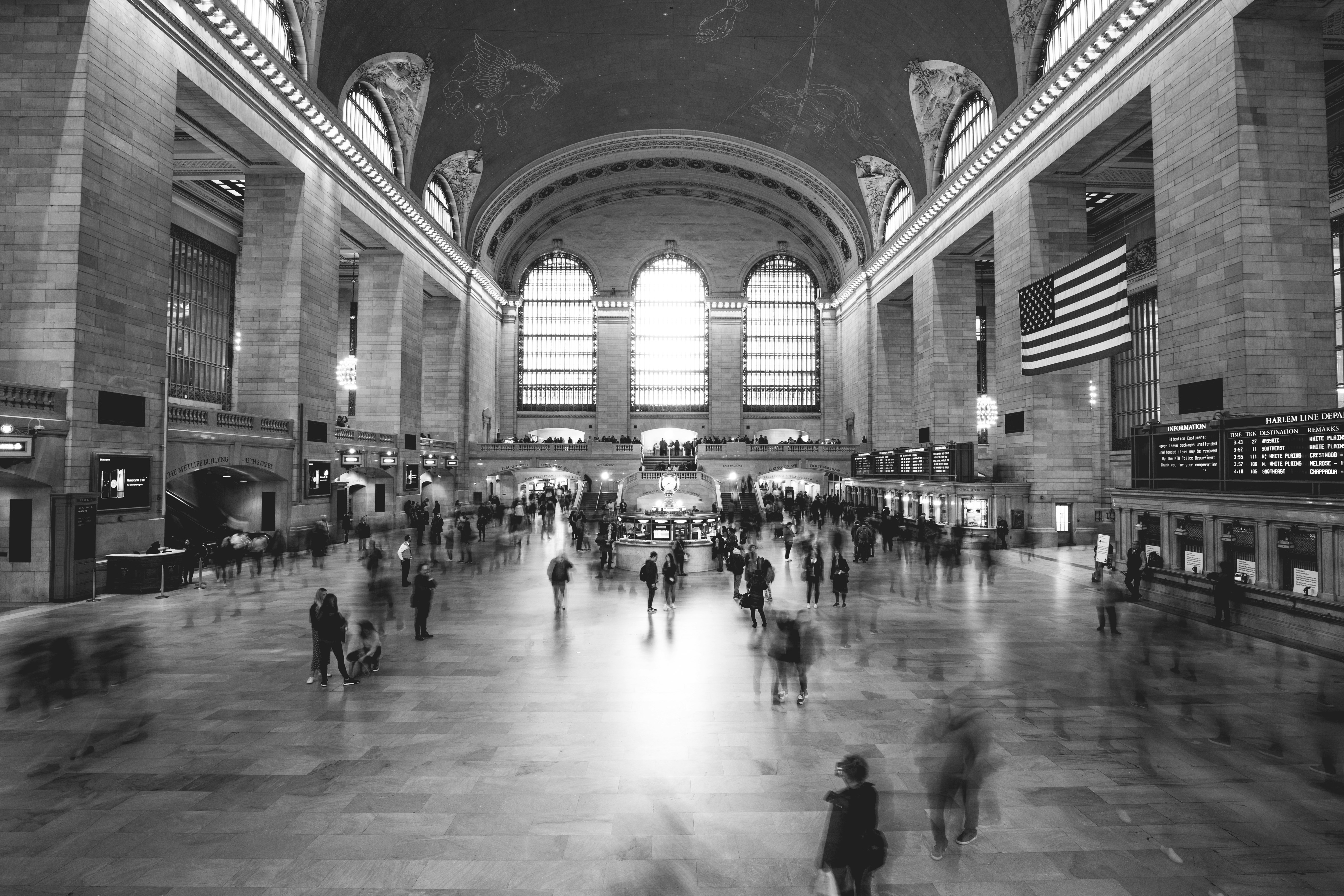 grayscale photography of people inside building