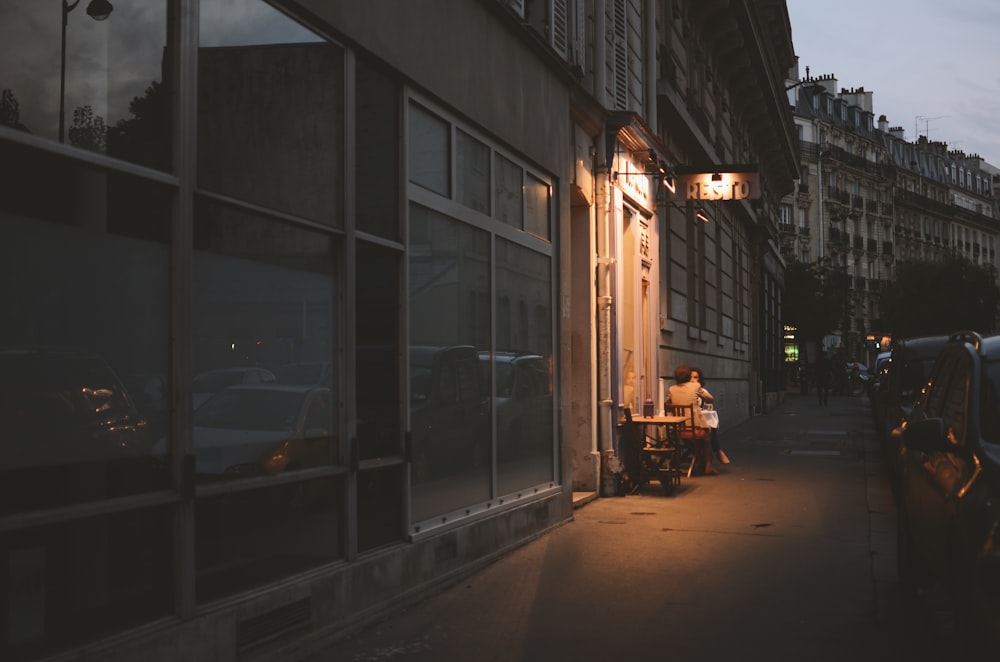 vehicles parked beside buildings at nighttime