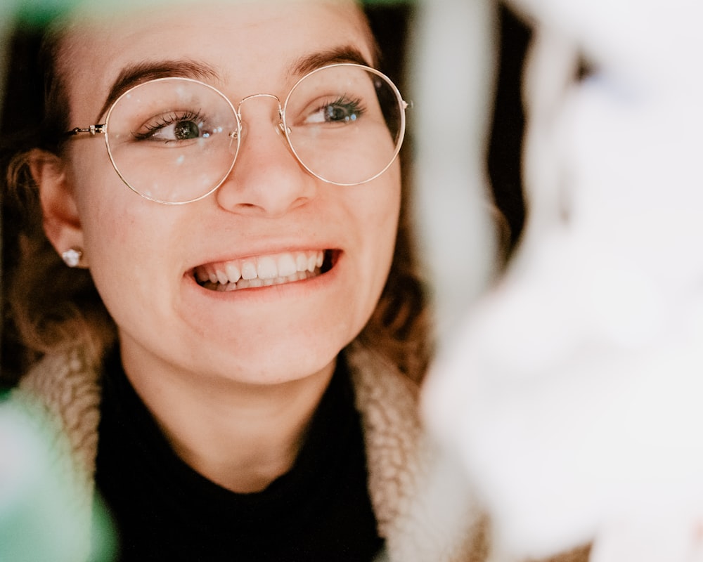 smiling woman wearing round eyeglasses