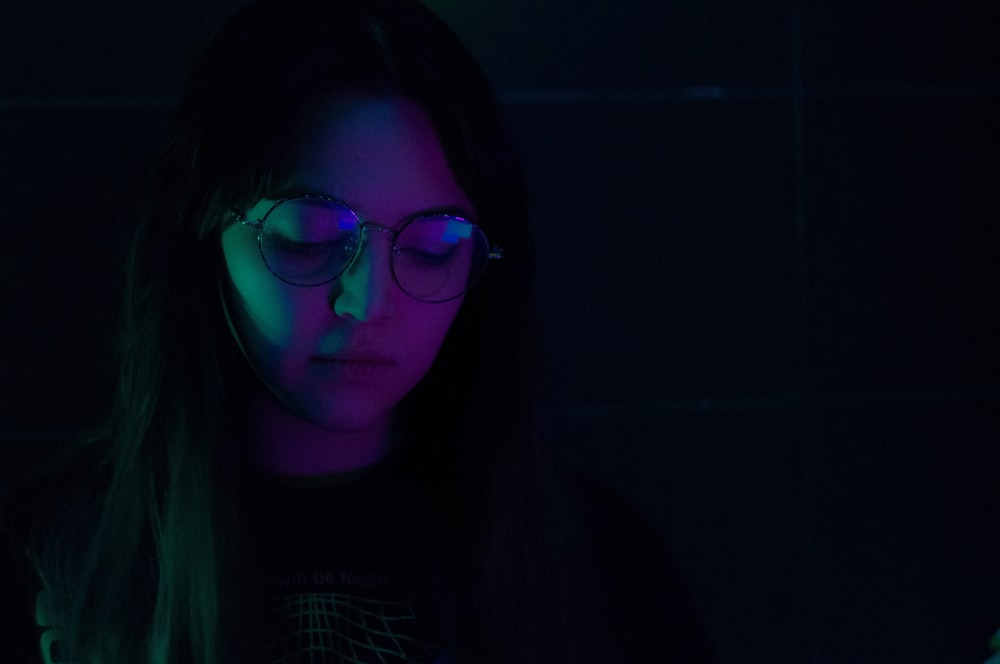 woman wearing eyeglasses inside lit room