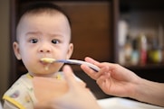 person feeding baby