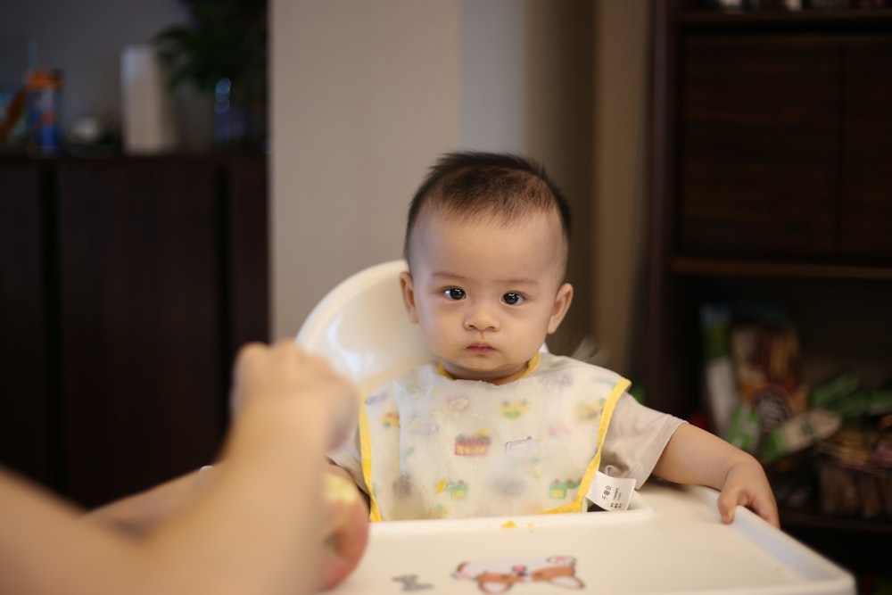 baby sitting on highchair