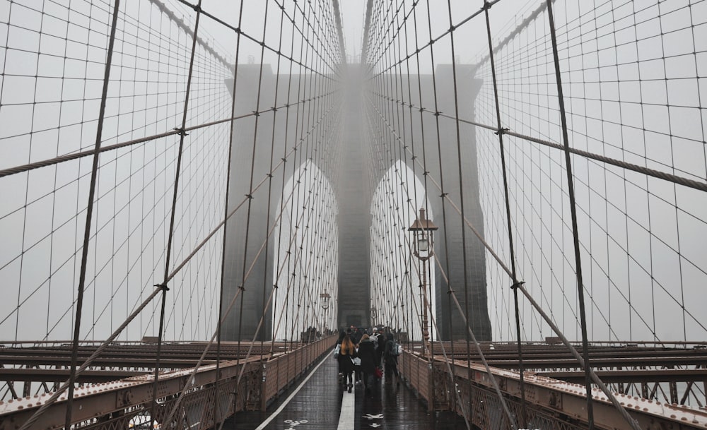 people walking on Brooklyn Bridge