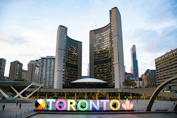 A moody, neon-lit Toronto skyline with a holographic AI interface overlay.