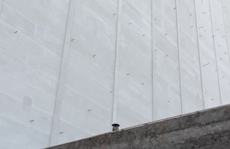 Headwall structure beside a drainage channel, showcasing precise concrete formwork.