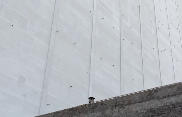 Headwall structure beside a drainage channel, showcasing precise concrete formwork.
