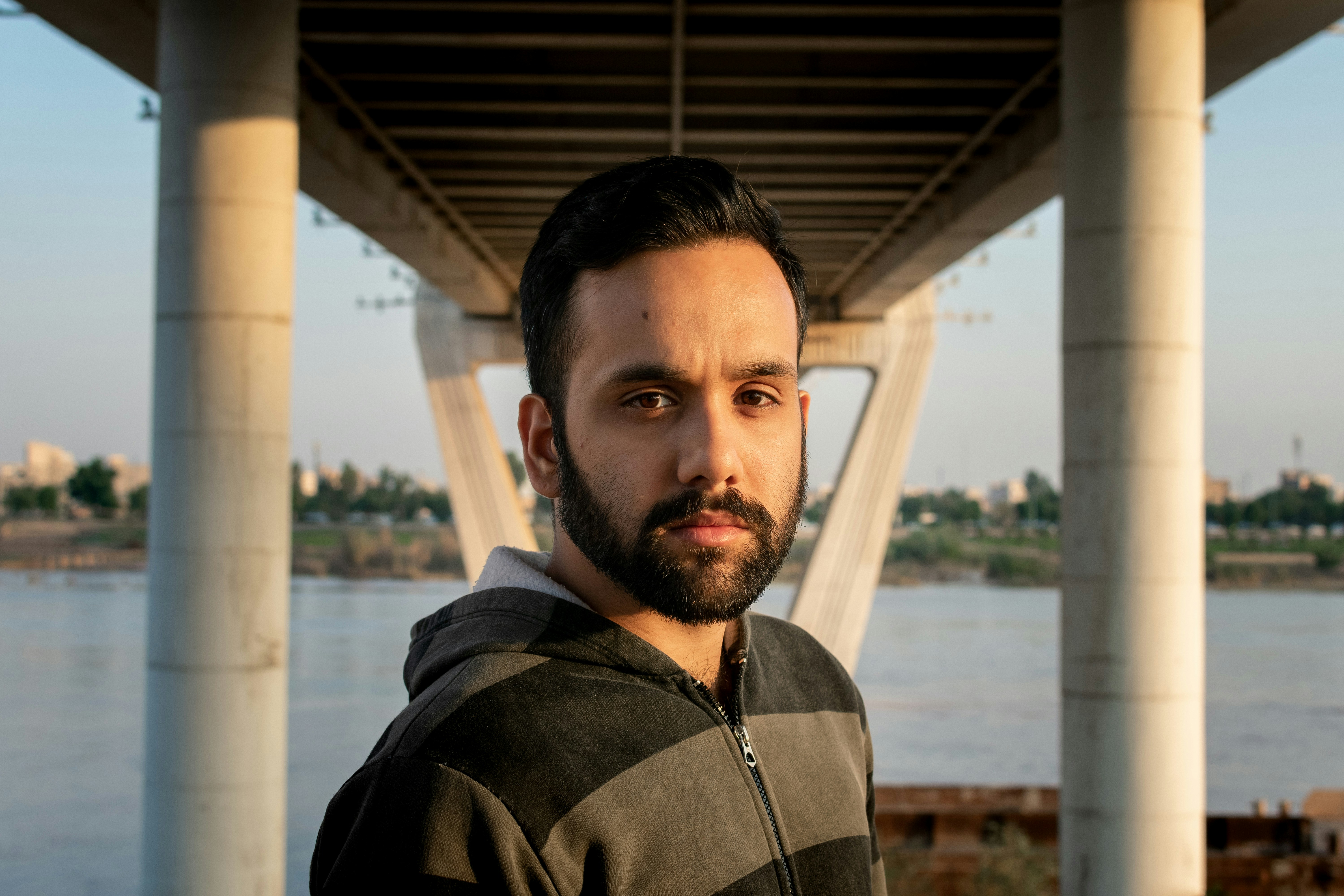man standing under bridge iranian teams background
