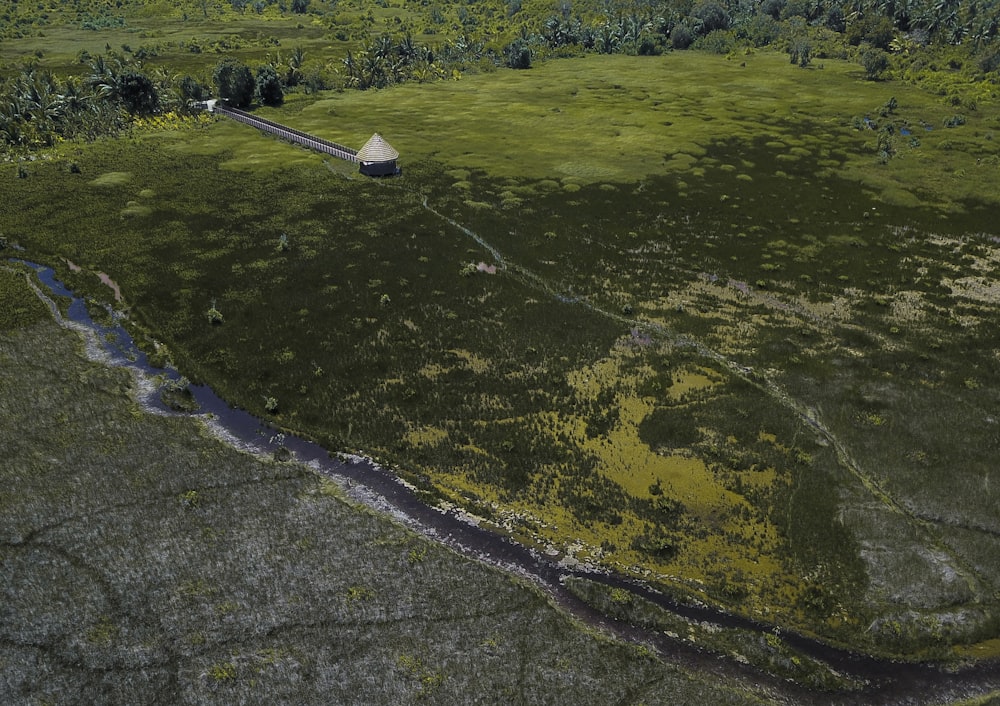 aerial view of house on green field