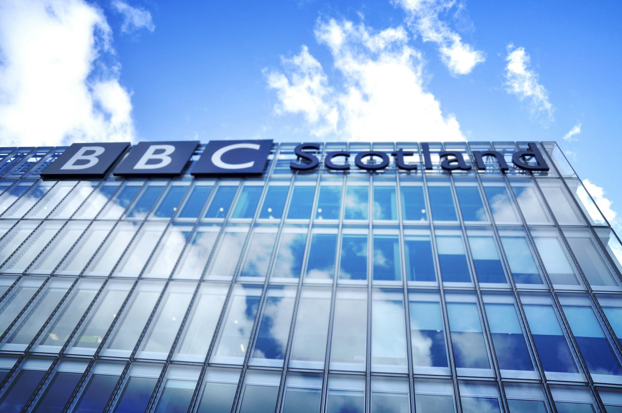 low angle photo of BBC Scotland building under blue sky