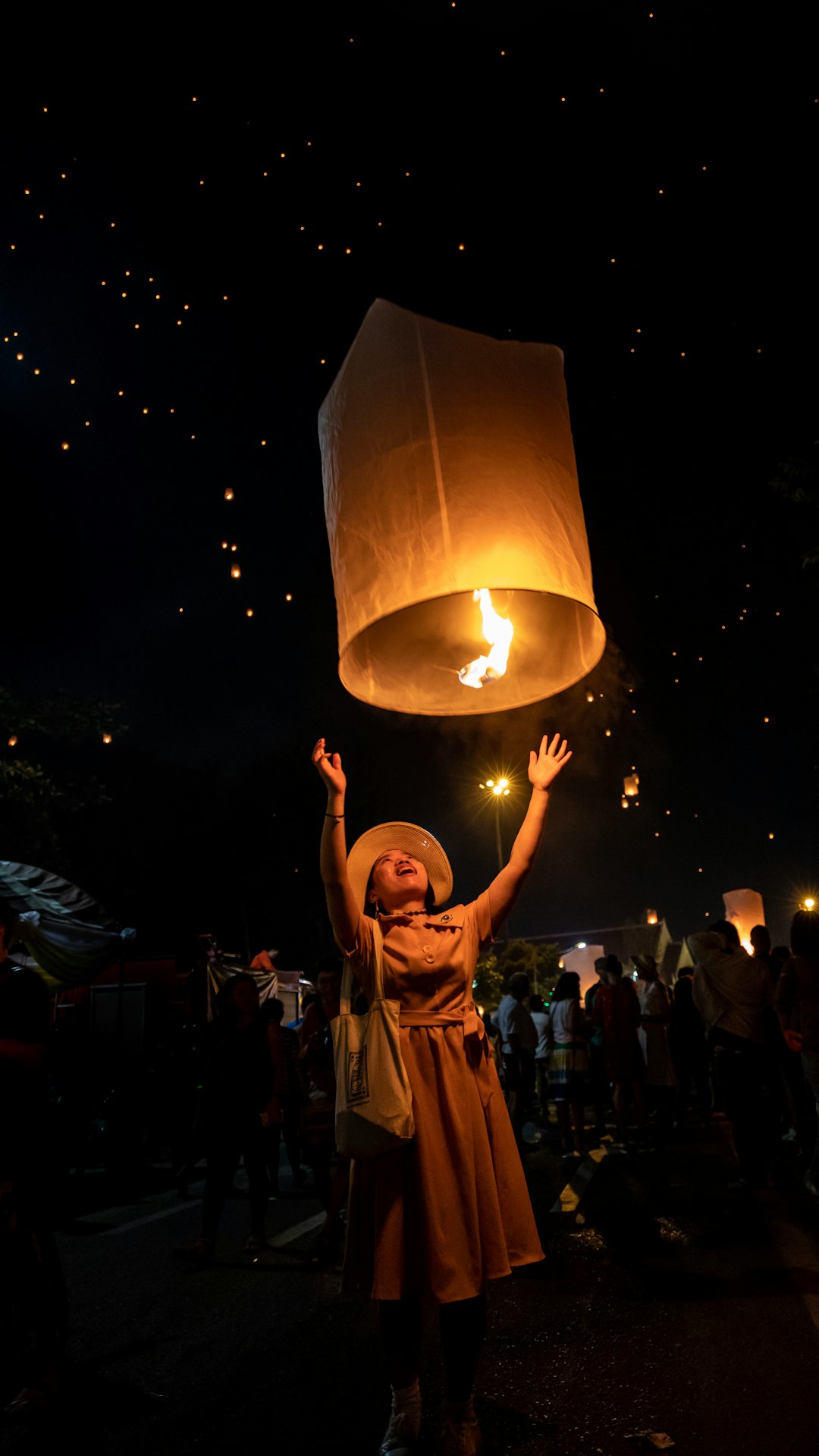 During Loi Krathong the Festival of Lights in Chiang Mai I saw this Chinese girl (Ji Jing) suited in her skirt and wearing a hat releasing her lantern and took the chance to take the photo.