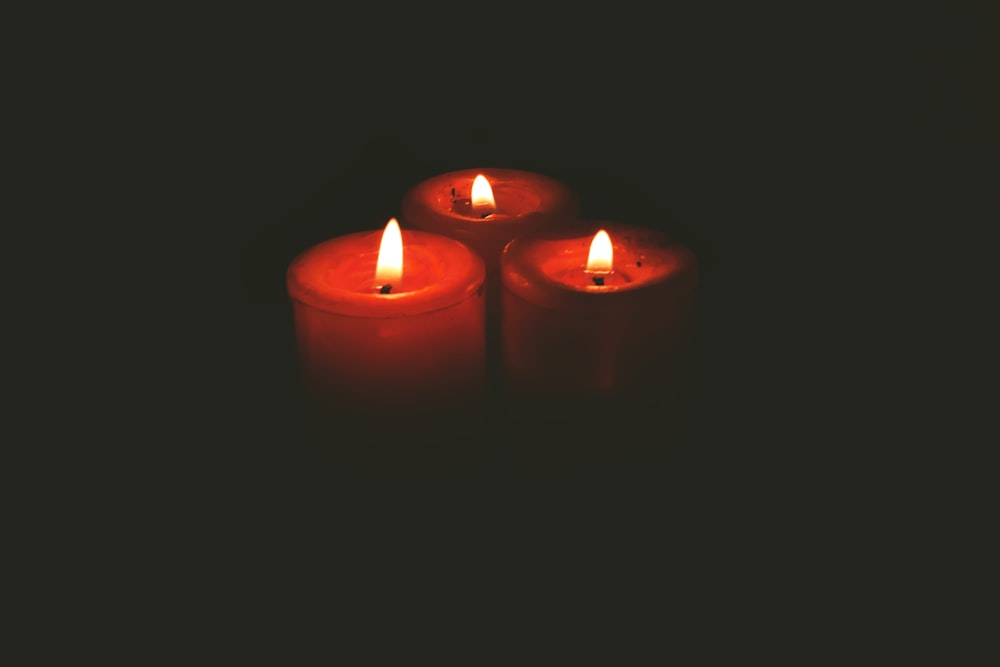 three red lit pillar candles