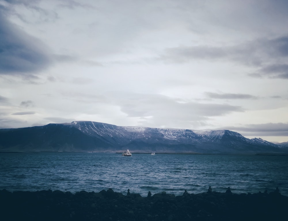 nature photography of mountain under cloudy sky during daytime