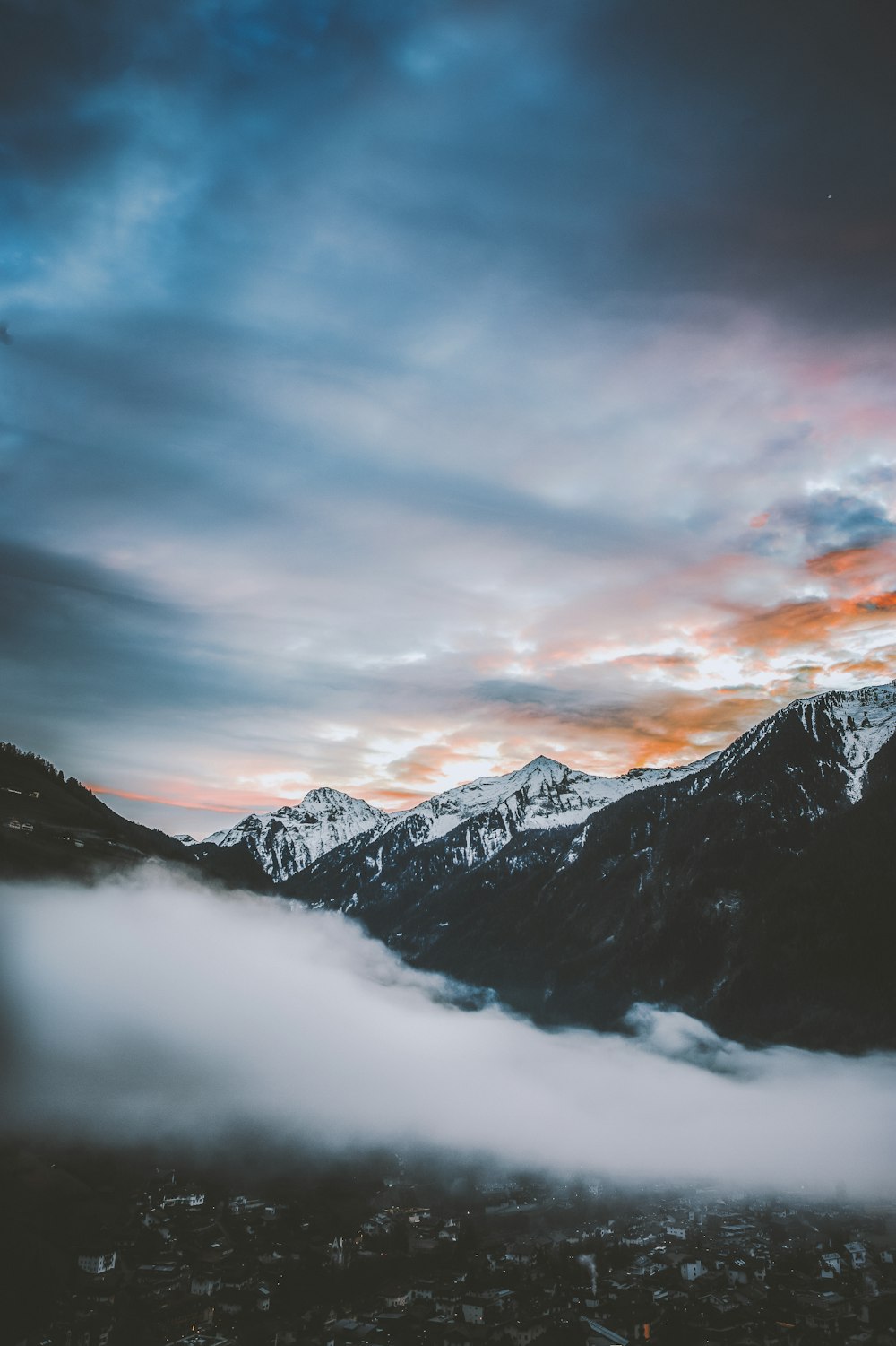 white cloud covering snow-covered mountain