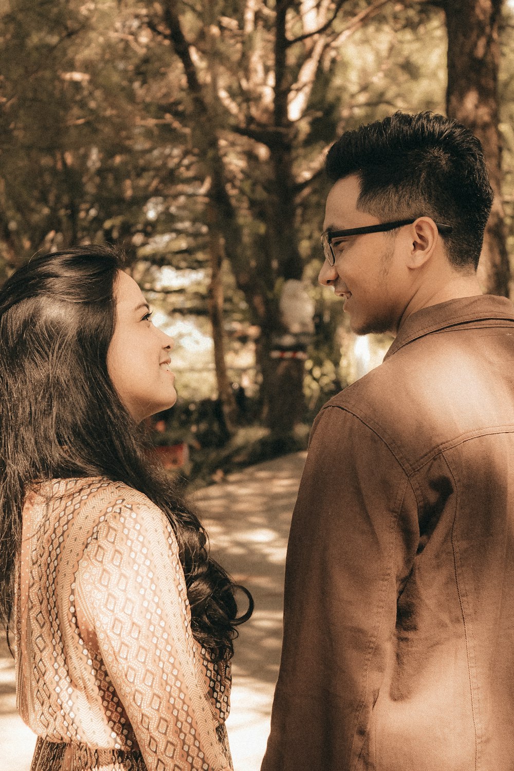 sepia photography of man and woman looking at each other