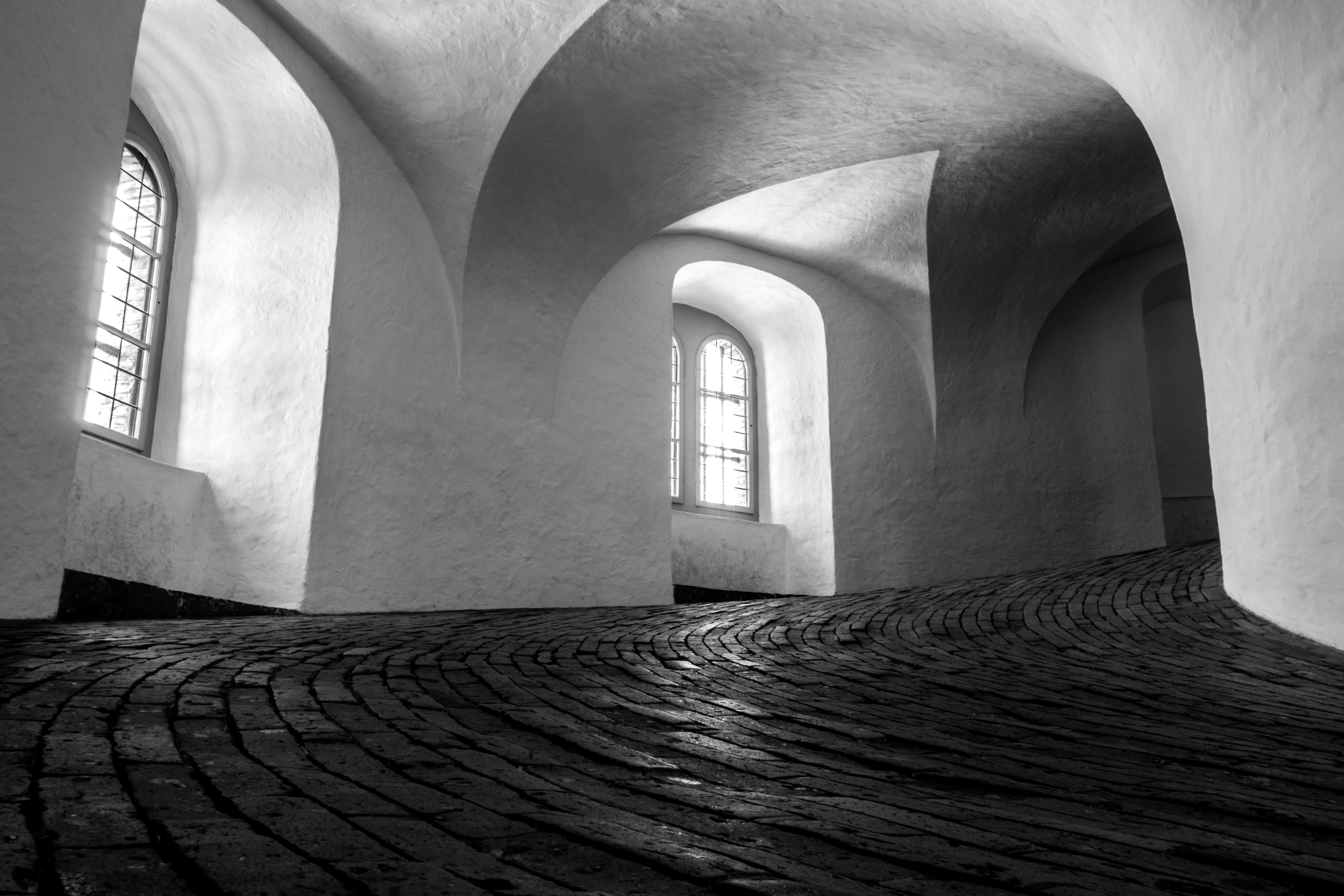 grayscale photography of concrete building hallway