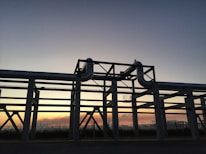 Close-up of oil and gas pipeline infrastructure with a sunset backdrop.