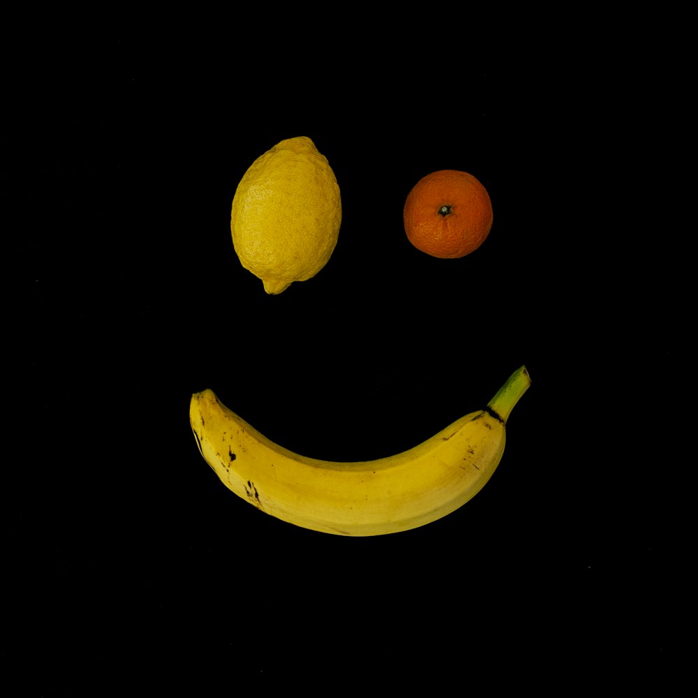 yellow lime, orange fruit, and yellow banana with smile formation