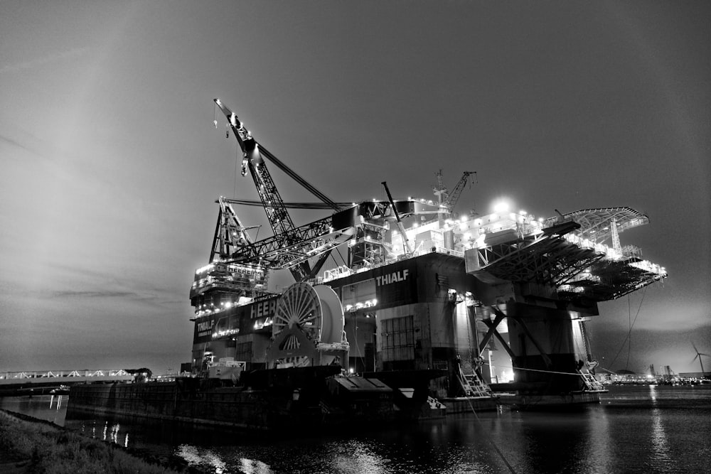 grayscale photography of oil rig